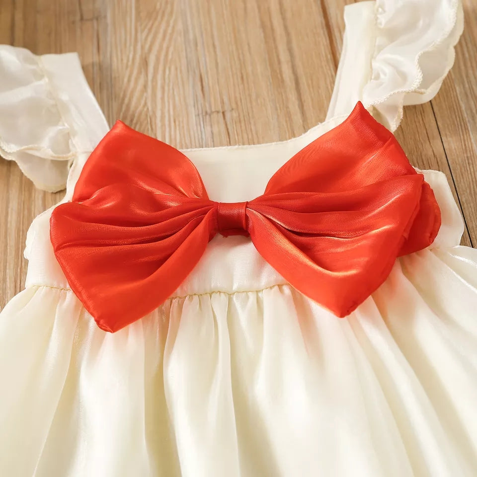 Vestido navideño brilloso y moño frontal rojo