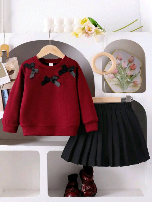 Mangas largas con detalles en moños+ falda plisada