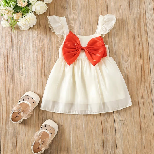 Vestido navideño brilloso y moño frontal rojo